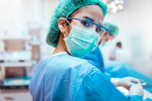 surgical waitlist management solution - surgeon looking back at the camera during surgery