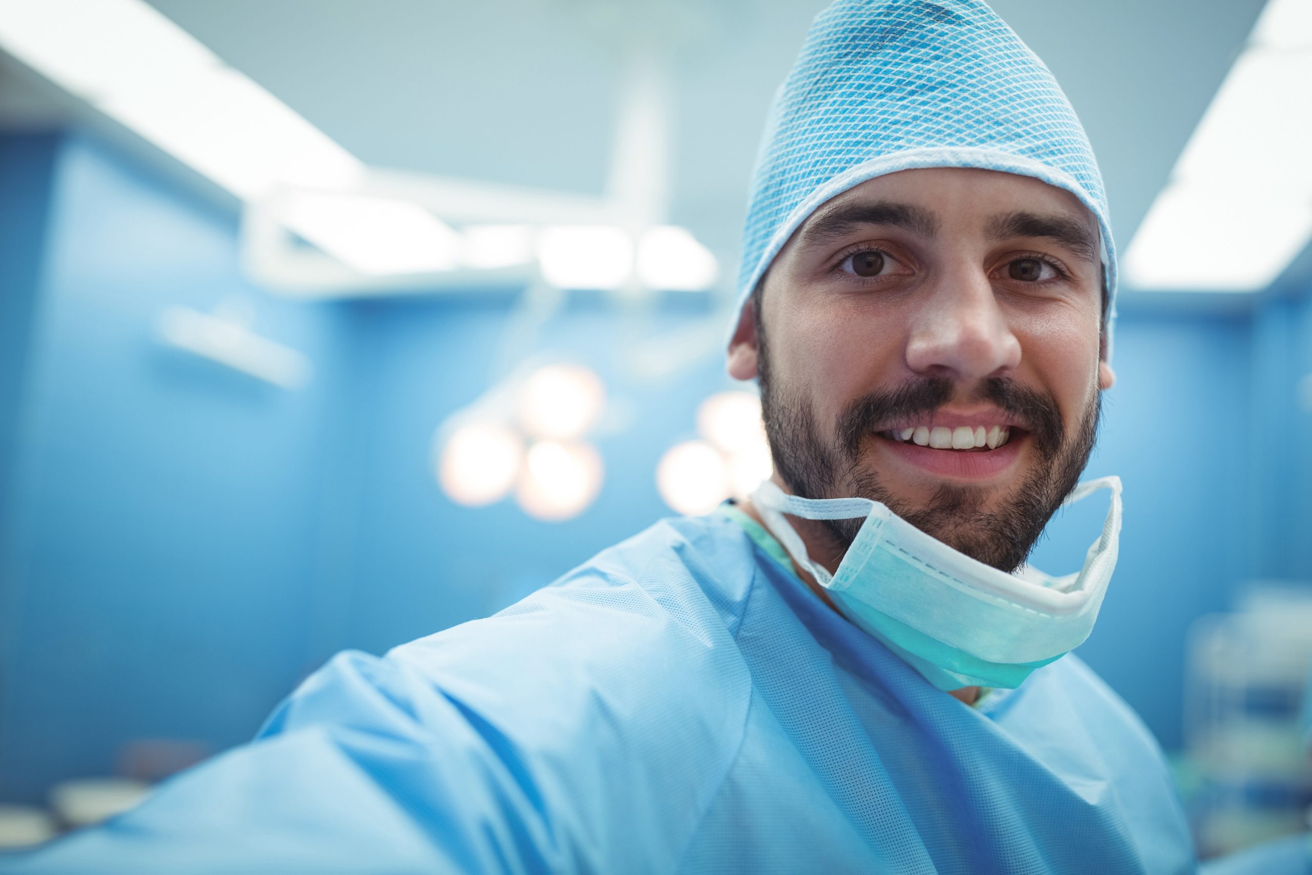 male surgeon smiling happily because of an optimized surgical room