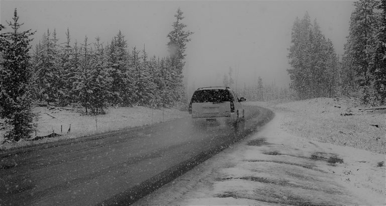 car driving on a snowy highway to demonstrate the difficult conditions Northerners face seeking health services